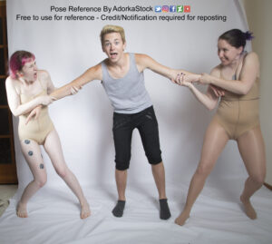 Two female models holding onto the arms of a male model in the middle as if using him in a tug of war