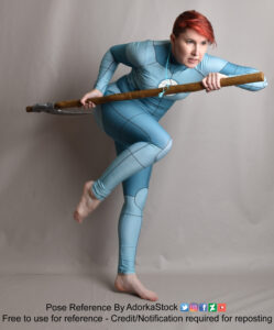 woman in an anatomy grid suit standing on one foot holding a scythe blade behind her