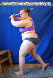 fat white female model taking a step and swinging a blade overhead