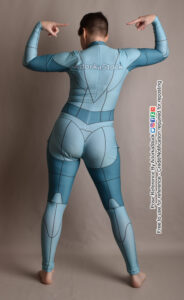 thin white female pose reference model standing facing away pointing to her back