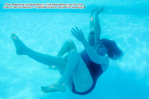 two models one male and one female sinking down in the water
