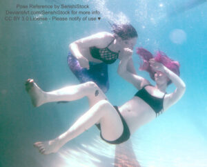 Two white women, one of which appears to be falling backwards and "drowning" (on the right) and the woman on the left is wearing a mermaid tail, trying to catch her.