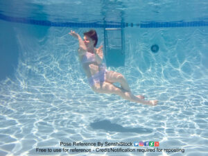 thin white female model underwater in floating pose