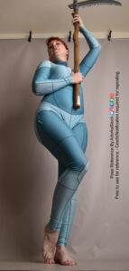 female model in an anatomy grid suit, shot from a low angle, one leg slighting in front of the other, holding up a scythe