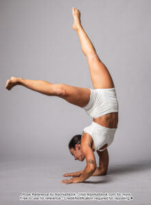 fit Latina model coming out of a chin stand, legs in the air