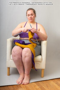 fat white female model sitting in a chair knitting