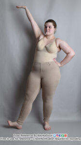 pose reference model standing with one arm up, the other on a hip with one foot kicked out