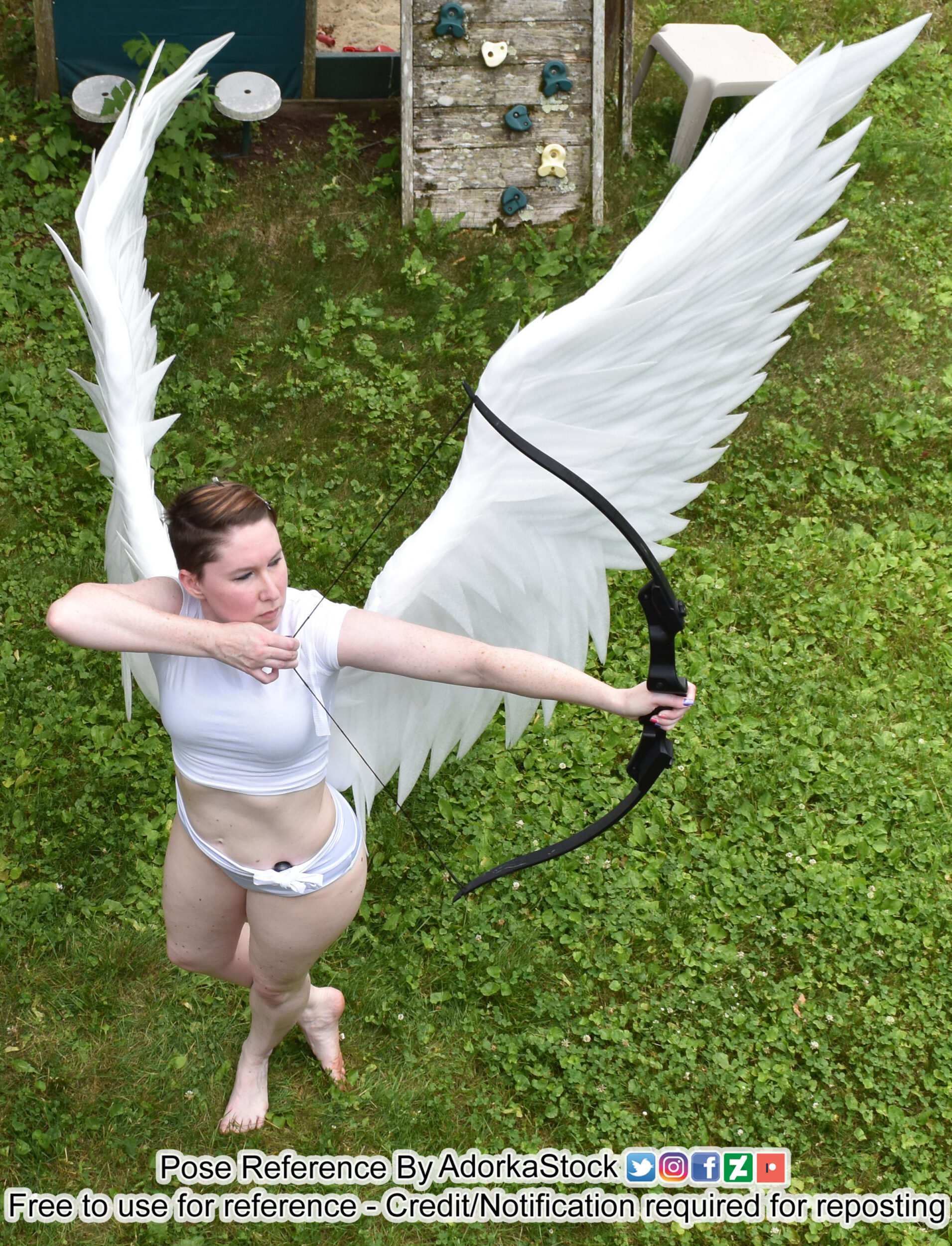 high perspective pose reference of a model with wings and a bow and arrow notched to shoot to the side