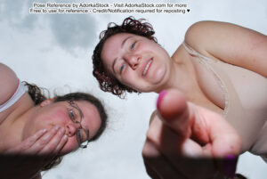 portrait pose reference of two people standing over the camera gasping and pointing down