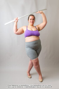 fat white female pose reference model standing in heels with a katana over her head