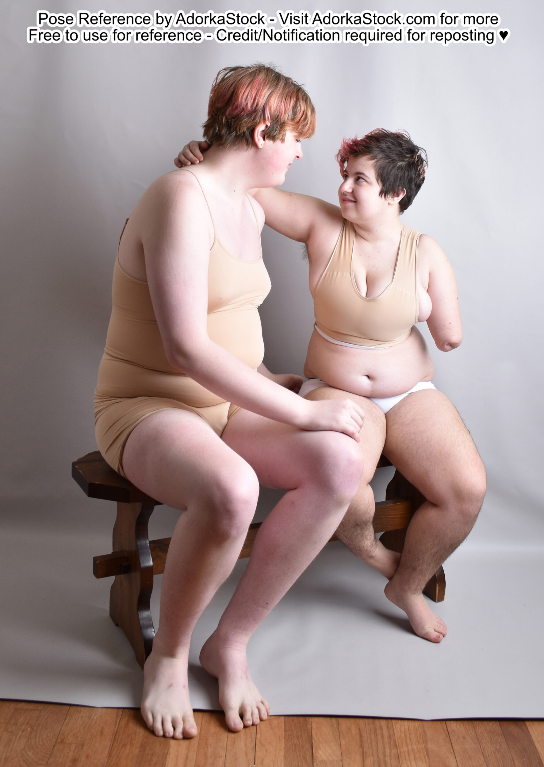 two models sitting together one very tall one very short they look companionable