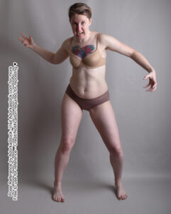 thin white female pose refernce model in a dynamic action pose as if casting a magic spell with clawed hands