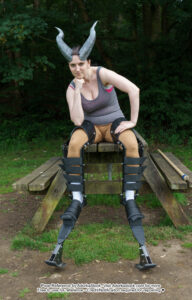 pose reference model wearing digitigrade legs in sitting pose with head on fist