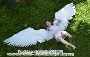 thin, white, female pose reference model in high perspective laying pose with huge wings on her back