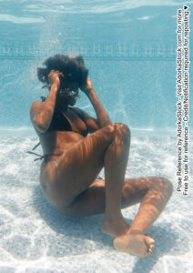 thin, Black, pose reference model in curled up pose underwater grabbing at hair