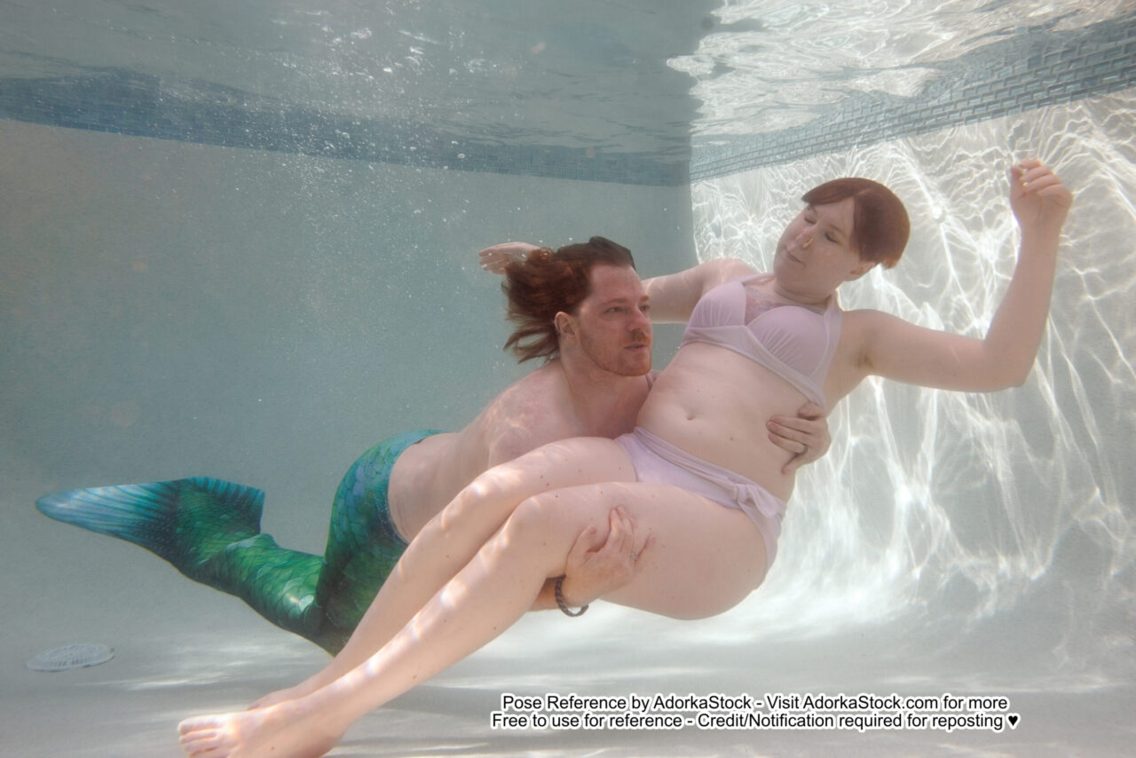 a merman swims through the water and scoops up a floating woman in his arms
