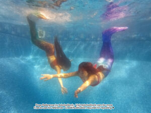 Two mermaids underwater