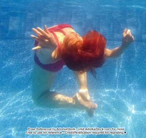 thin Asian female model underwater in a back bend with head and feet towards the camera