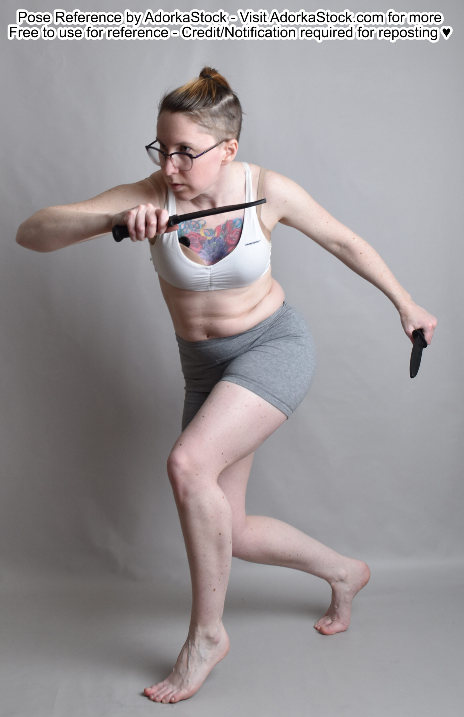 thin white female model in a dynamic running pose with a blade in each hand