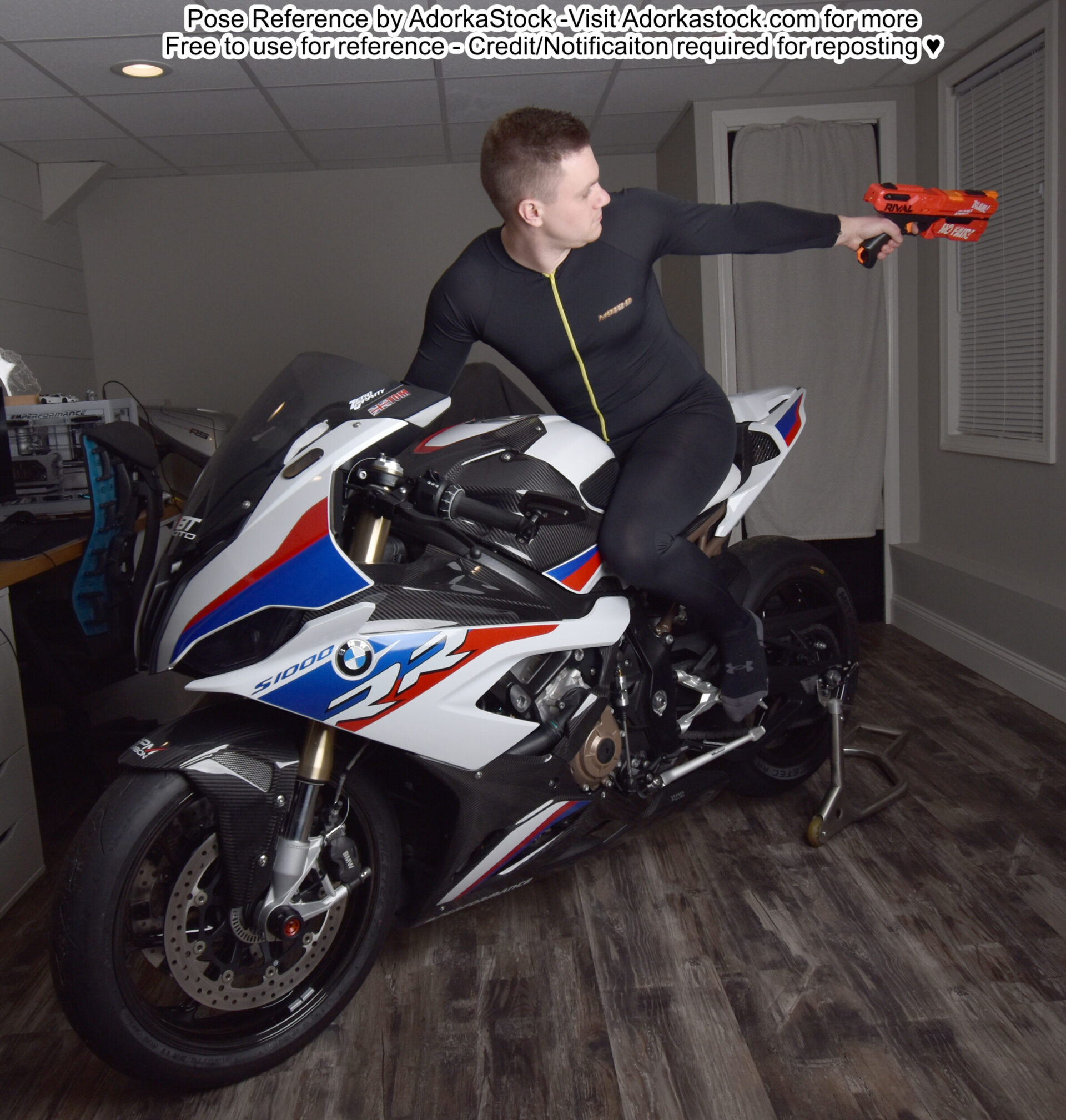 thin white male model sitting on a motorcycle shooting a nerf gun behind him