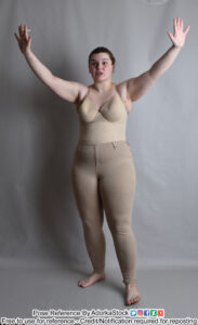 a model standing with arms raised palms towards the camera, taking a step as if trying to stop someone or something